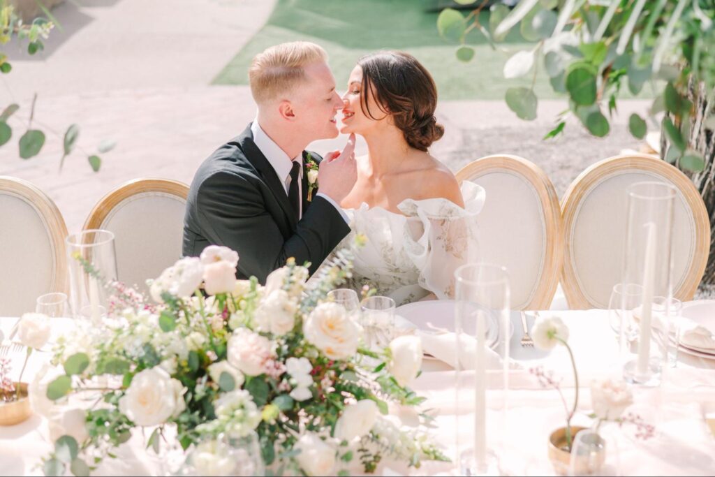 bride and groom sit outside at La Posada de Santa Fe