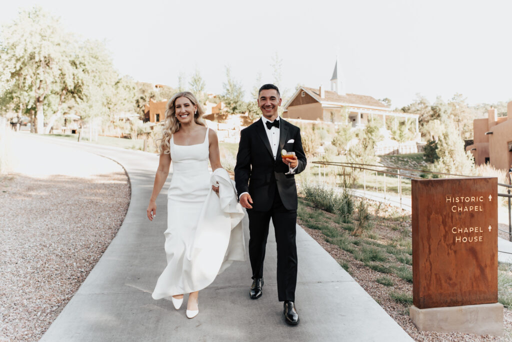 a cheerful couple walking near a historic chapel