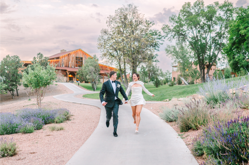 Bride and groom running together for photos at Bishop's Lodge