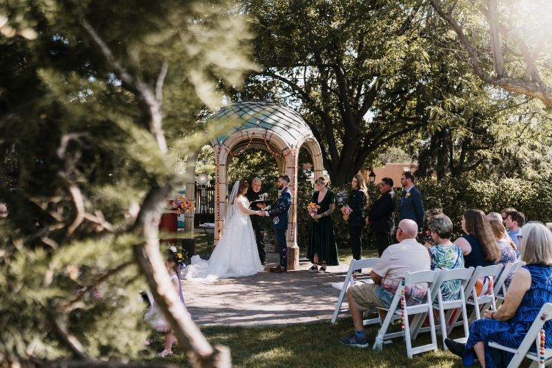 Bride and groom exchange vows under mosaic dome, their wedding day order of events running smoothly.