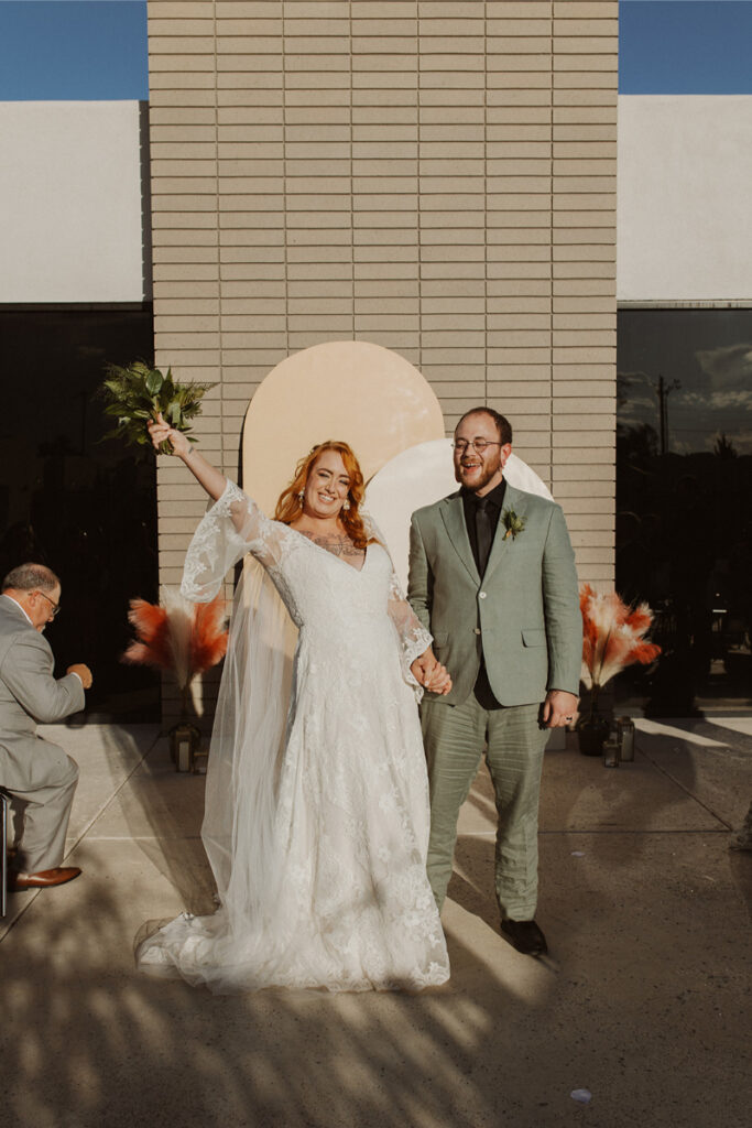 Couple celebrate after exchanging vows during their fall wedding in New Mexico.