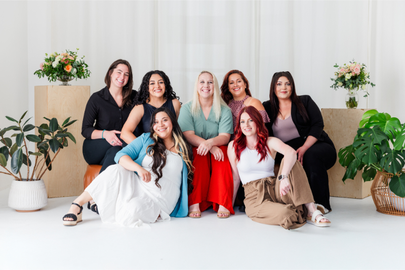 Lace and Bow Bridal team sit for group photo showcasing all the Albuquerque wedding planners on their team.