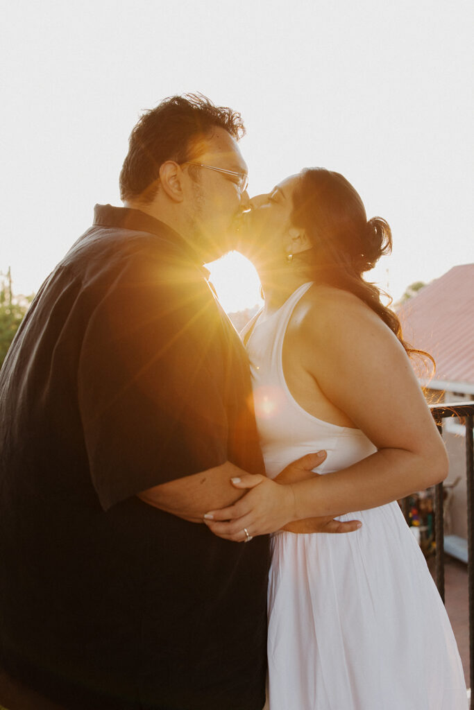 Boyfriend kisses his girlfriend after proposal.