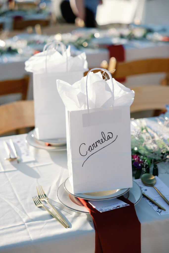 Gift sit on table setting for wedding reception.