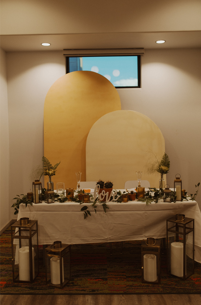 Repurposed ceremony backdrop for sweetheart table at fall wedding in New Mexico.