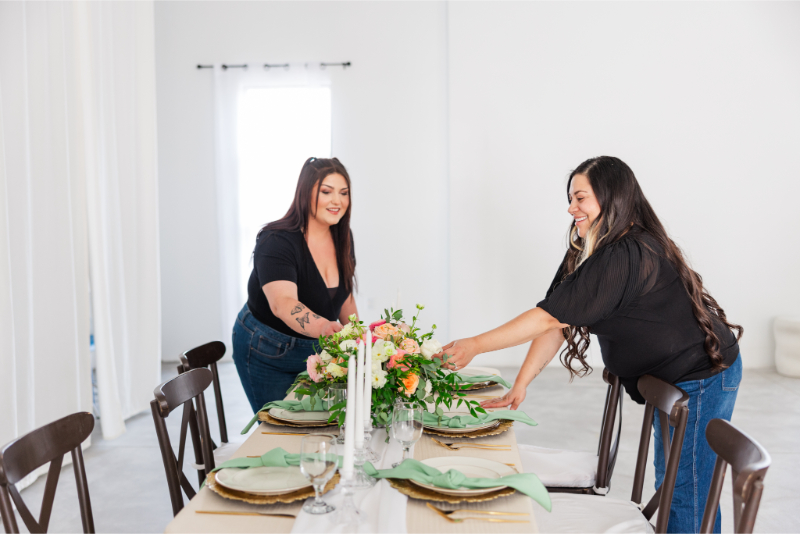 Albuquerque wedding planners from the Lace and Bow team get tablescape ready for styled shoot.