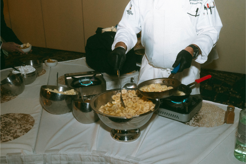 Chef prepares bananas foster for wedding reception dessert.