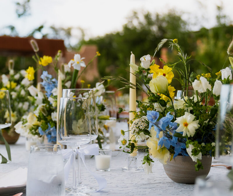 Low floral centerpiece on reception table for garden wedding at Bishop's Lodge in Santa Fe.
