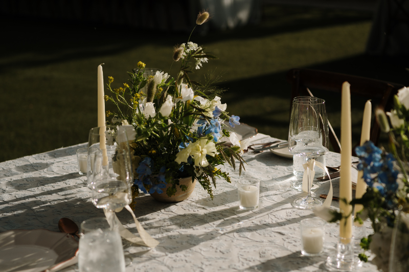 Low floral centerpiece on reception table for garden wedding at Bishop's Lodge in Santa Fe.