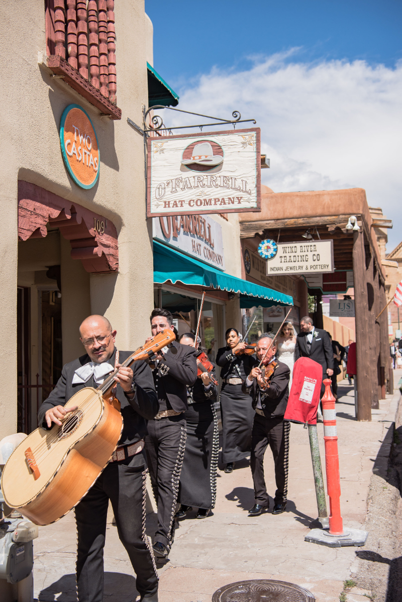 Mariachi band leads guests through downtown Santa Fe to cocktail hour at the Inn and Spa of Loretto.