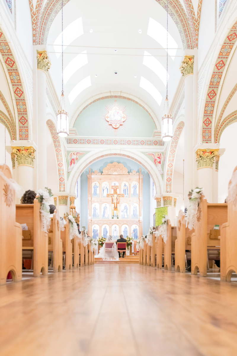 Bride and groom sit for ceremony at Loretto Chapel.