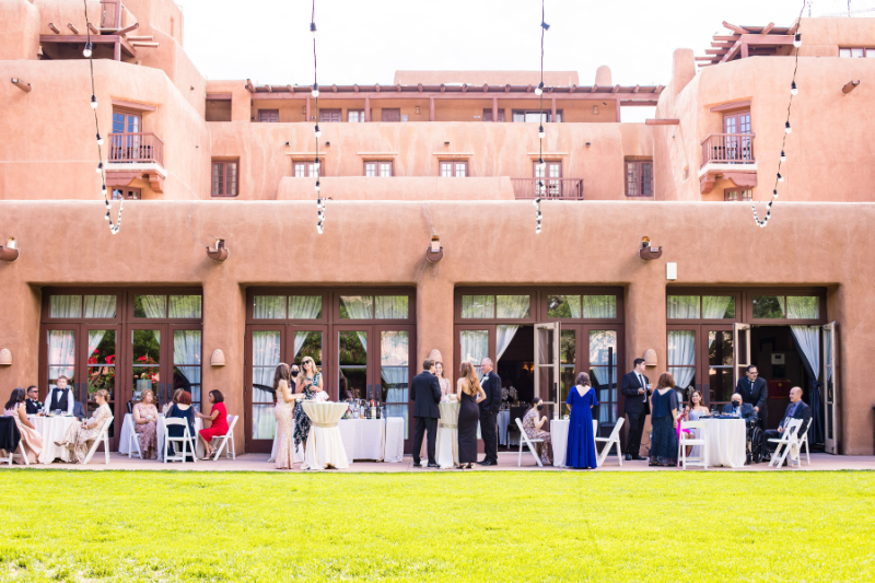 Guests mingle on lawn of the Inn and Spa at Loretto.
